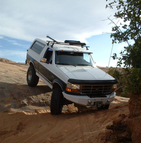 1993 Ford Bronco - This 1993 Ford Bronco is navigating a challenging off-road course in a desert landscape.