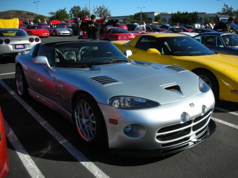 1992 Ford Crown Victoria - A silver Dodge Viper is parked in a lot with other sports cars, including a yellow Corvette.