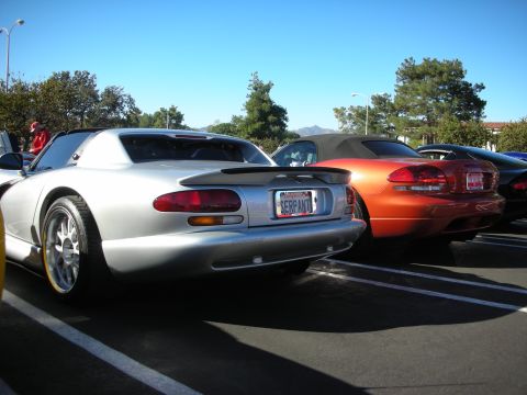 1992 Ford Crown Victoria - Silver and orange Dodge Vipers parked side-by-side on a sunny day.