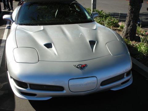 1992 Ford Crown Victoria - Front view of a silver Chevrolet Corvette C5, identifiable by its distinct body style and badging.