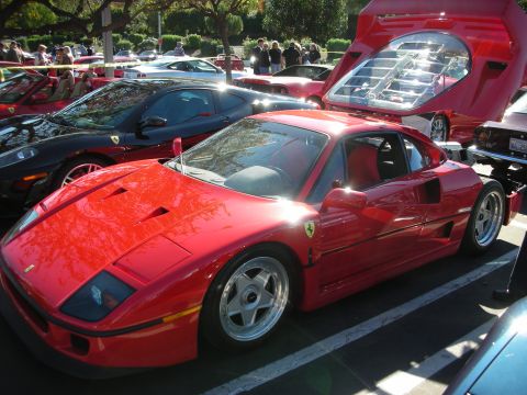 1992 Ford Crown Victoria - A red Ferrari F40 is parked at an outdoor car show, its engine cover lifted.