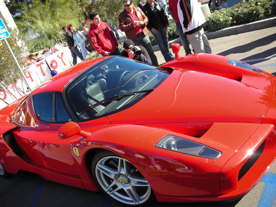 Red sports car with a Ferrari emblem on the fender