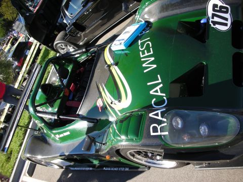1992 Ford Crown Victoria - A green race car with racing decals and the number 176 is parked next to a black vehicle.