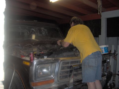 1978 Ford Bronco - Working on the engine of a 1978 Ford Bronco, with the hood open and various parts visible.