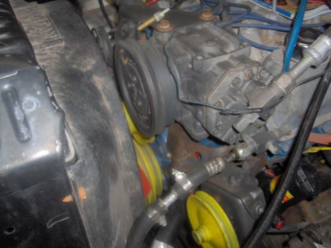 1978 Ford Bronco - Close-up view of engine components, including the air conditioning compressor and belts.