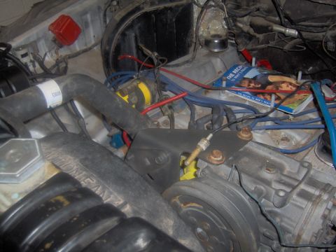 1978 Ford Bronco - Engine bay details with a magazine visible on top of engine components.