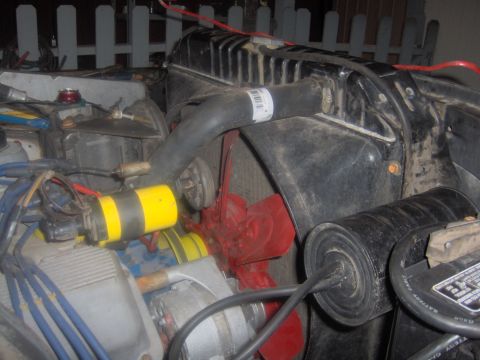 1978 Ford Bronco - Close-up view of an engine bay, showing the radiator, fan, and ignition coil.