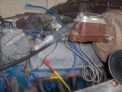 1978 Ford Bronco - Close-up view of an engine bay, showing the brake master cylinder and associated plumbing.