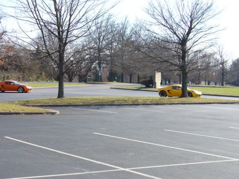 1991 Ford Probe - Two sports cars are parked in an outdoor lot with bare trees and a bright sky.