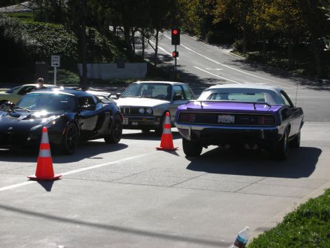 1992 Ford Crown Victoria - Purple 1970 Plymouth Barracuda convertible seen from the rear, with other cars nearby.