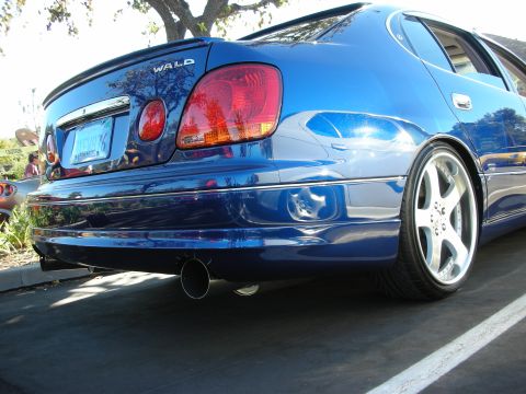 1992 Ford Crown Victoria - Rear view of a blue sedan with aftermarket WALD badging and custom wheels.