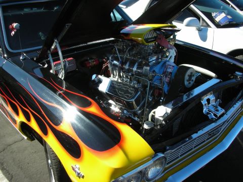 1992 Ford Crown Victoria - This custom hot rod features a powerful engine with flame graphics on the hood and fender, parked next to another vehicle.