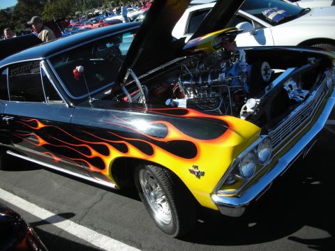 1992 Ford Crown Victoria - Customized classic car with flame paint and V8 engine on display at an outdoor car show.