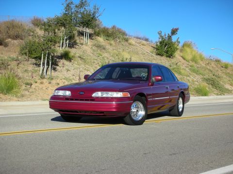 1992 Ford Crown Victoria - This maroon 1992 Ford Crown Victoria sedan is captured from a 3q-front angle on a sunny day.