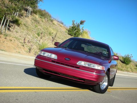 1992 Ford Crown Victoria - Front 3/4 view of a red 1992 Ford Crown Victoria on a sunny day.
