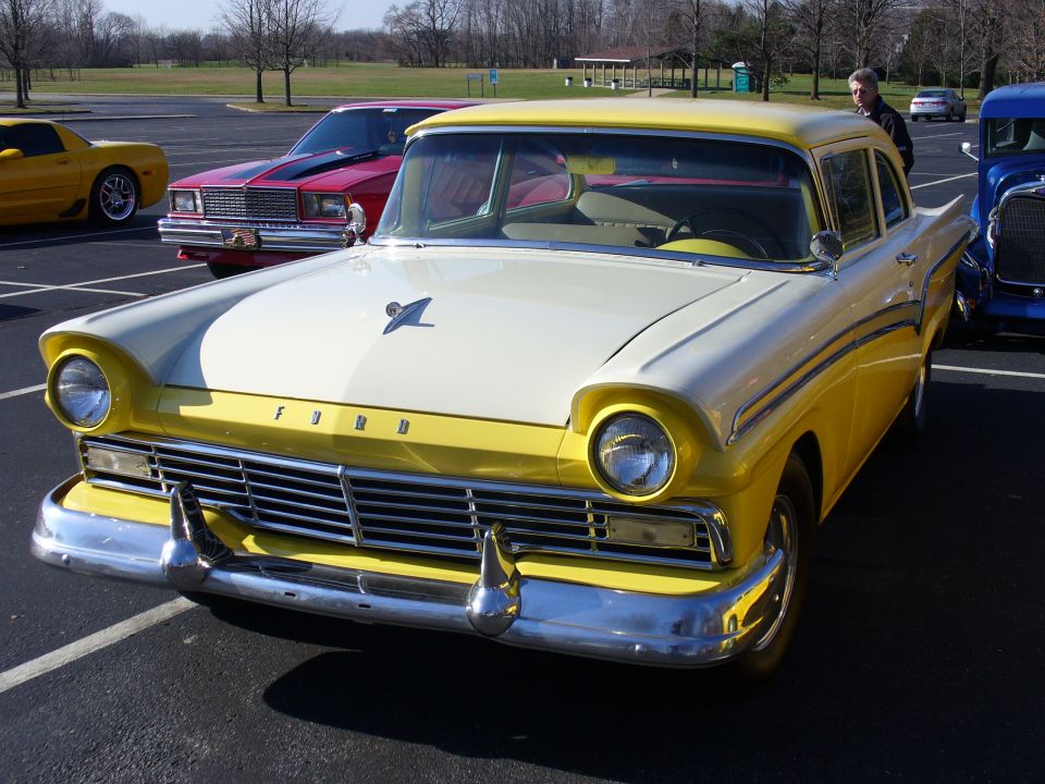 Yellow and white 1957 Ford sedan with chrome grille and bumpers, front view