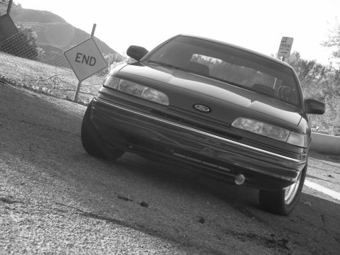 1992 Ford Crown Victoria - 1992 Ford Crown Victoria parked near an "END" sign on a sunny day.