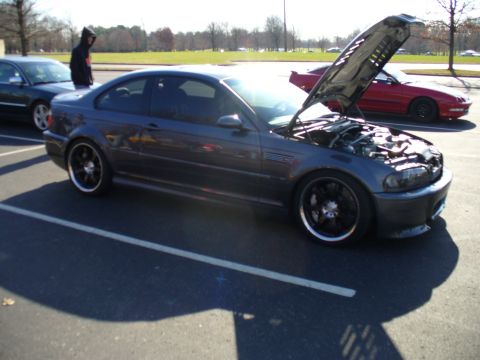 1991 Ford Probe - A dark gray coupe is parked with its hood open, revealing the engine compartment. Another vehicle is visible in the background.