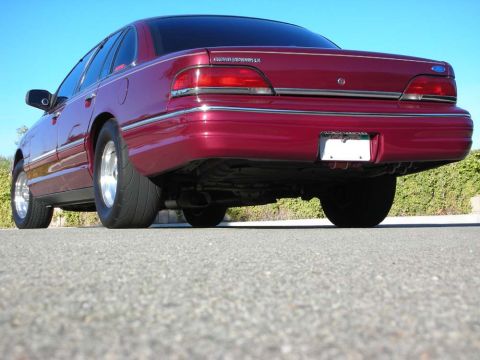 1992 Ford Crown Victoria - Rear view of a red 1992 Ford Crown Victoria LX sedan with custom wide rear tires.