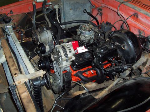 1972 Chevrolet C/K Pickup - Close-up view of a V8 engine and its components within the engine bay.