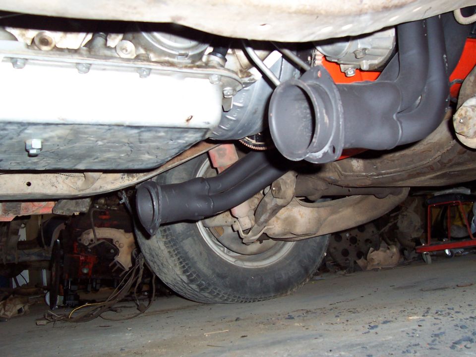 Underbody view of exhaust headers and rear axle of a truck
