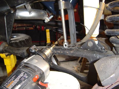 1986 Ford Bronco - Close-up view of a drill being used on a vehicle's frame, likely for a modification or repair.