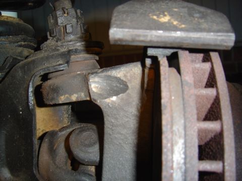 1986 Ford Bronco - Close-up view of a vehicle's brake rotor and caliper assembly.