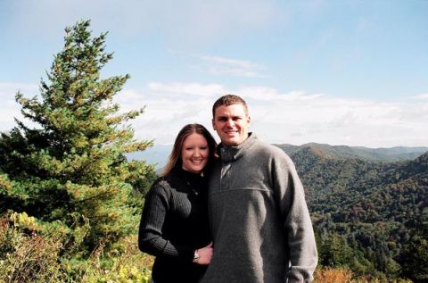 1999 Ford Mustang - A couple smiles for the camera with a scenic mountain vista behind them.