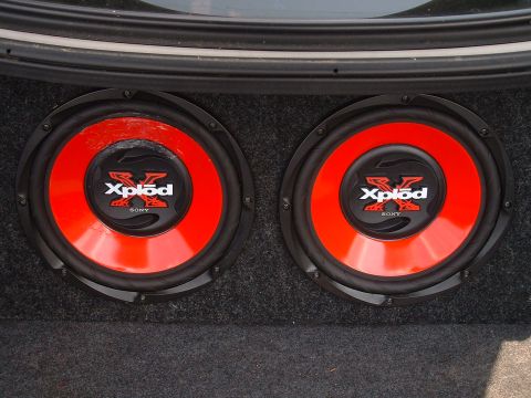 1997 Ford Taurus - Car trunk interior showing a pair of Sony Xplod subwoofers.