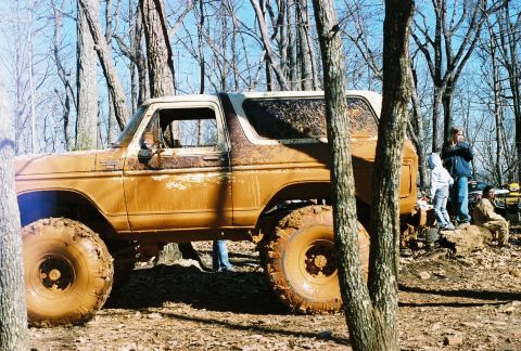 1978 Ford Bronco - This heavily modified 1978 Ford Bronco is covered in mud, suggesting it has been used for off-roading.