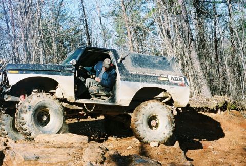 1978 Ford Bronco - This modified SUV navigates a challenging off-road course with steep inclines and rocky terrain.