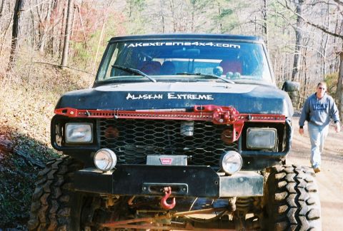 1978 Ford Bronco - Modified 1978 Ford Bronco with off-road equipment, including a winch and Hi-Lift jack, parked outdoors.