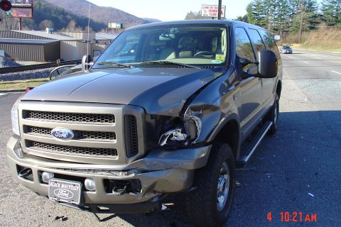 2002 Ford Excursion - This 2002 Ford Excursion sustained damage to its front passenger side, including a missing headlight.