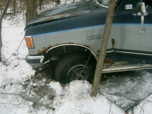 1990 Ford Bronco stuck in snow, front fender rusted