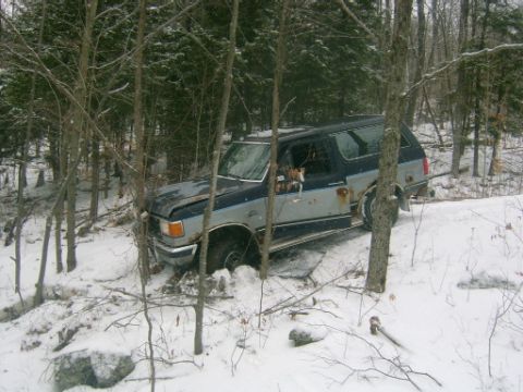1990 Ford Bronco - This Ford Bronco appears to be from the early 1990s and is stuck in a snowy, wooded area.