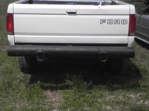 1997 Ford F-250 - Rear view of a white Ford F-Series truck, showing its tailgate and bumper.