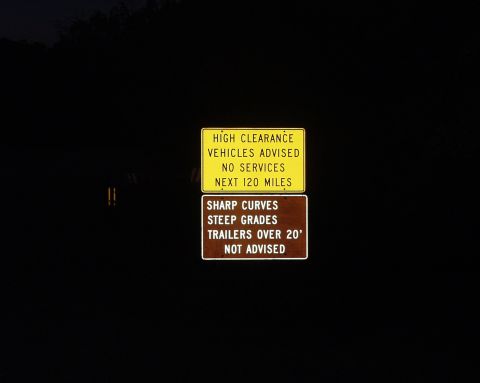 1997 Ford F-250 - Road signs indicate upcoming hazards and lack of services for 120 miles.