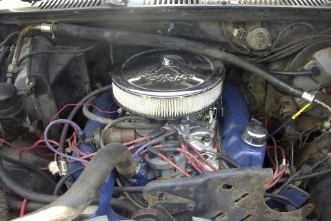 1984 Ford Bronco - Close-up of an engine bay, an aftermarket air cleaner and various hoses and wires.