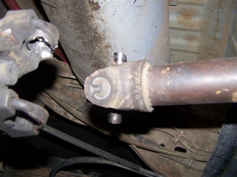 1995 Ford Bronco - Undercarriage view of a damaged driveshaft U-joint, indicating potential mechanical issues.
