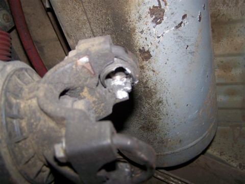1995 Ford Bronco - Close-up of a damaged driveshaft universal joint, showing significant wear and metal debris.