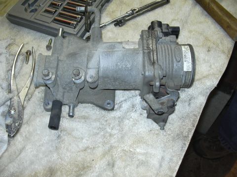 1996 Ford Crown Victoria - Throttle body assembly removed from a vehicle, with tools nearby.