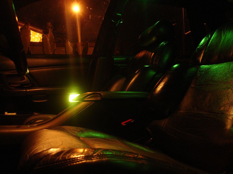 Car interior with leather seats and green ambient lighting