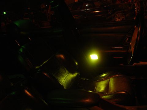 1993 Ford Taurus - Nighttime interior shot of a car, with ambient lighting highlighting the seats and door. Another vehicle is seen through the window.