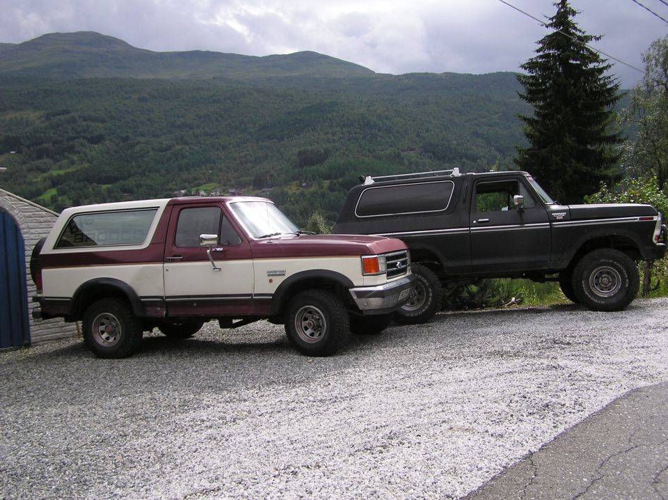 1978 Ford Bronco and a later model Ford Bronco parked side-by-side