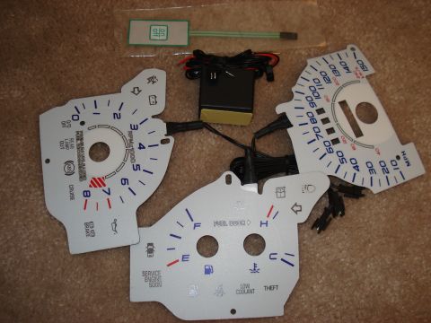 1998 Ford Taurus - Gauge cluster overlays and accessories for a vehicle, including wiring and a control module.