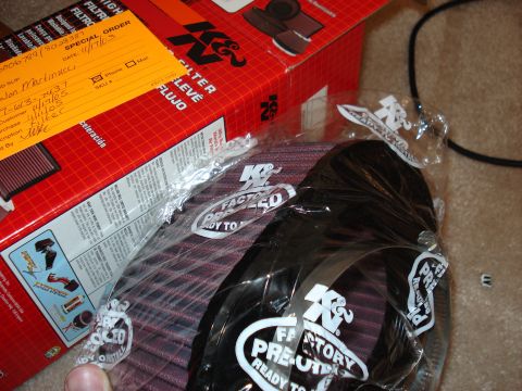 1998 Ford Taurus - A K&N air filter is shown in its packaging, with the product box and a special order slip visible.