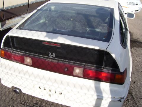 1993 Mazda MX-6 - Rear view of a white Honda CRX, identifiable by its unique taillight design and sloped rear window.