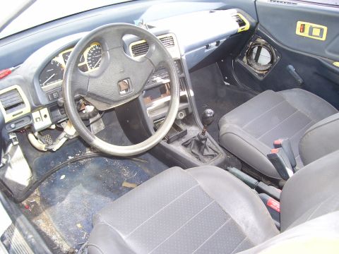 1993 Mazda MX-6 - Interior view of a car's cabin, a manual gearbox and dashboard details.