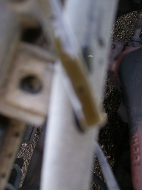1993 Mazda MX-6 - A close-up view of a fluid level indicator, likely from an engine bay, with no clear vehicle identification visible.