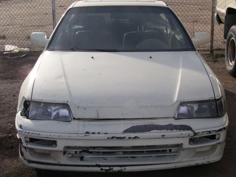 1993 Mazda MX-6 - Front end damage on a white car, possibly a 1990s Honda CRX.